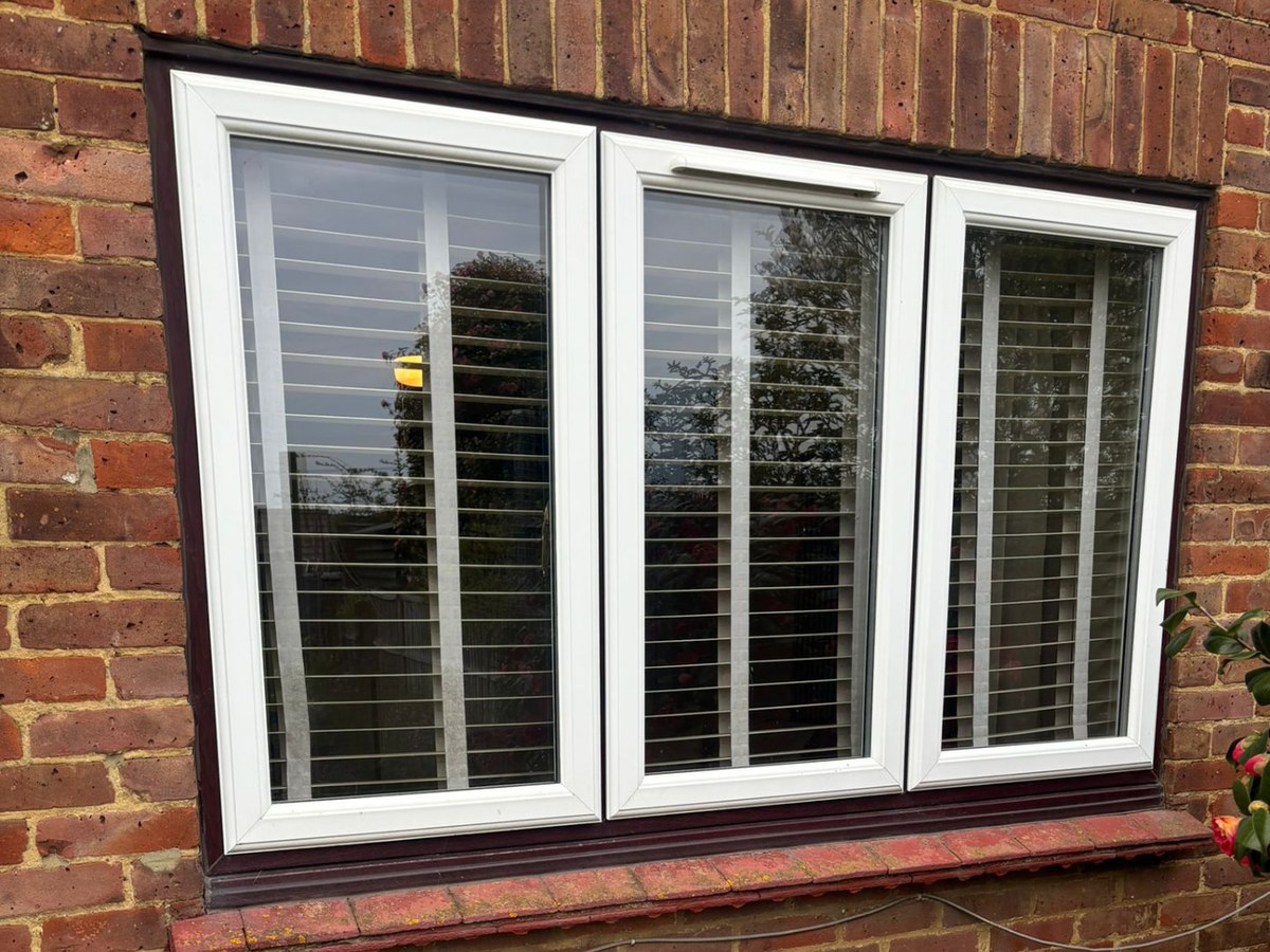 White uPVC casement window on a brick house
