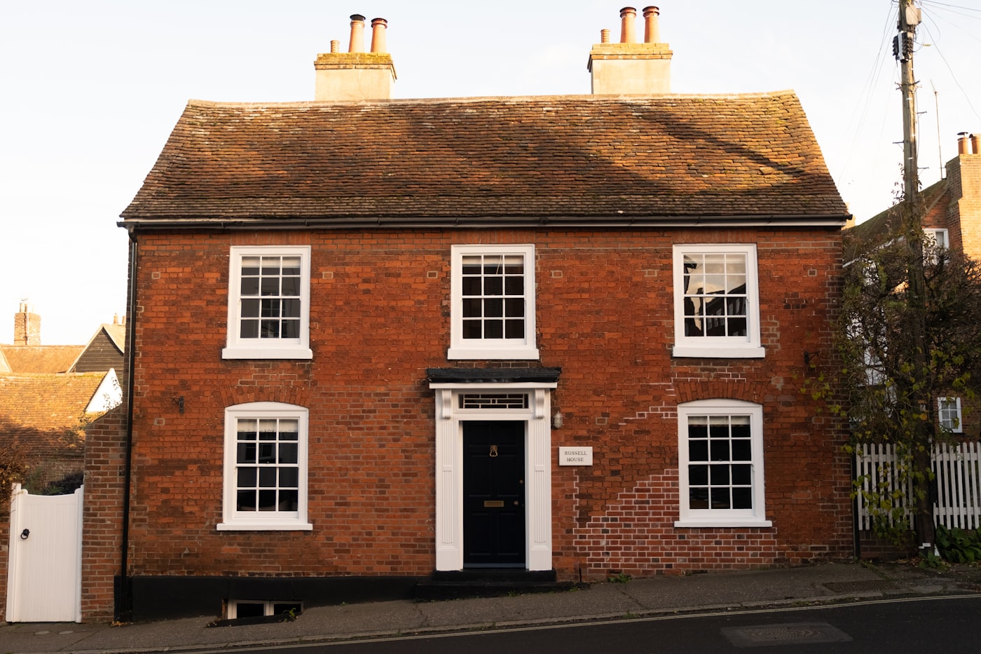 Stone-fronted UK townhouse with sash windows and iron railings