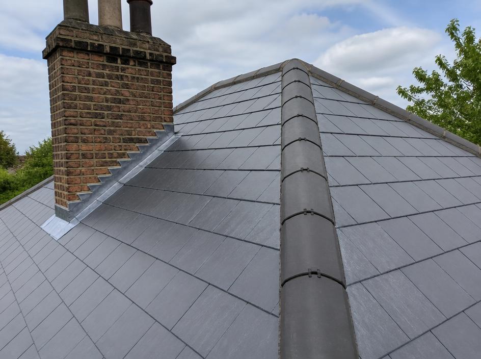 Well-maintained slate roof with lead flashing around a chimney