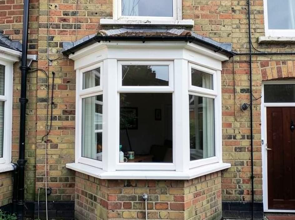 White uPVC bay window on a 1930s semi-detached house